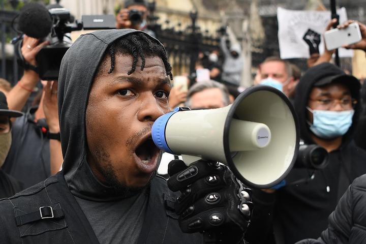 British actor John Boyega speaks to protestors in Parliament square during an anti-racism demonstration in London.