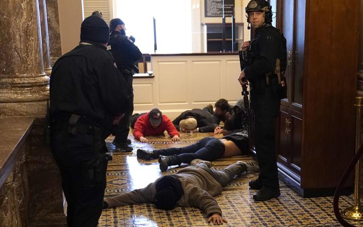 US Capitol Police detain protesters outside of the House Chamber during a joint session of Congress on January 06, 2021 in Washington, DC. 