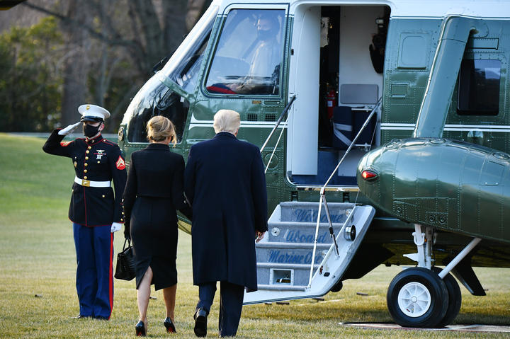 US President Donald Trump and First Lady Melania make their way to board Marine One before departing from the South Lawn of the White House in Washington, DC on January 20, 2021.