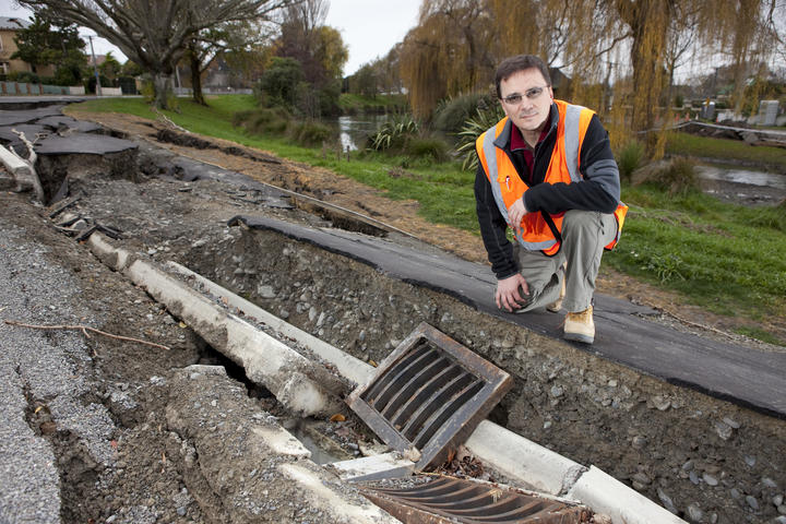Misko Cubrinovski, from the University of Canterbury's School of Engineering, studies liquefaction and lateral spreading on Oxford Terrace, after the 2011 Christchurch earthquake. 
