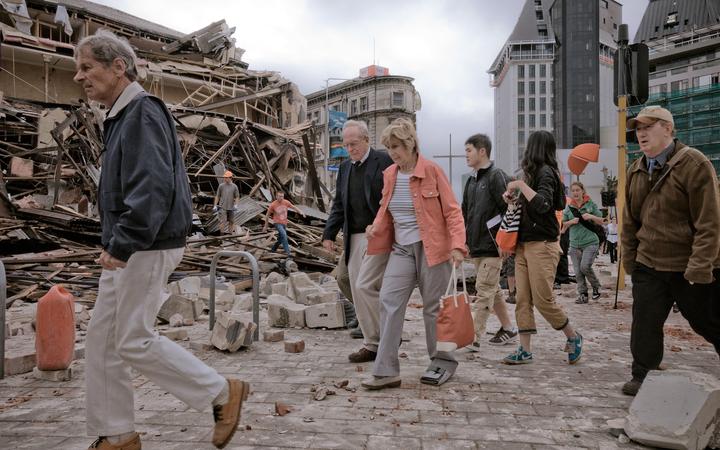 People walk through debris in the aftermath of the 22 February earthquake in Christchurch.
