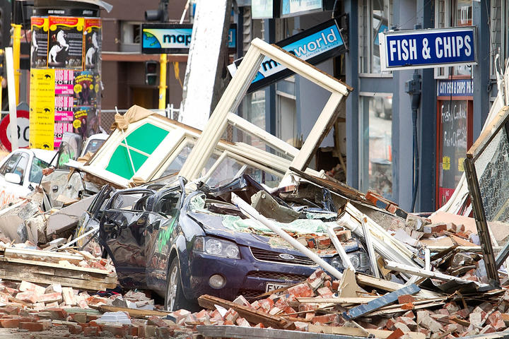 Cars are crushed under fallen rubble in Christchurch on 24 February 2011 - two days after the city's deadly earthquake.
