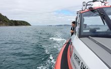 Coastguard crew look for the missing boat north of Auckland.