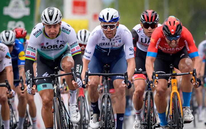 New Zealand cyclist Patrick Bevin (centre) after finishing third in a bunch sprint at the Tour of Romandie behind Peter Sagan (left) and Sonny Colbrelli (right) on April 28, 2021. 