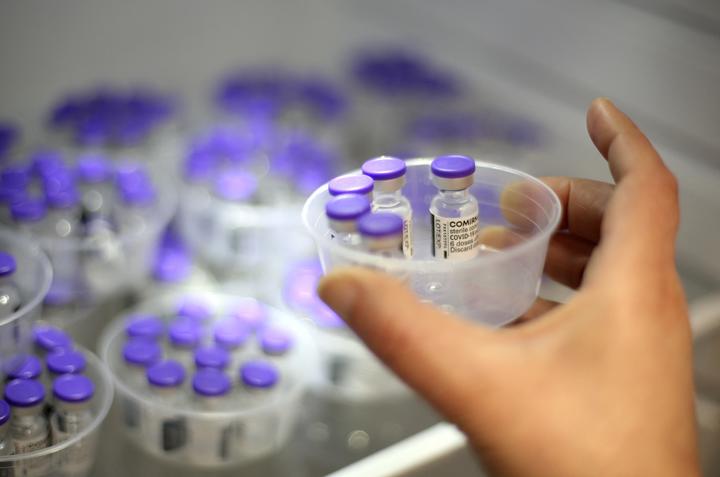 A nurse takes vials of Comirnaty vaccine by Pfizer-BioNTech against Covid-19 out of a fridge at the Baleone vaccine centre in Ajaccio on the French Mediterranean island of Corsica, on May 13, 2021. 