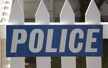police sign on fence 