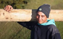 maori man with fence post 