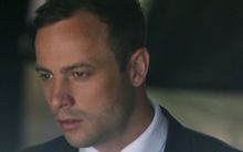 South African Olympic and Paralympic sprinter Oscar Pistorius is led to a prison van after his sentencing in Pretoria.