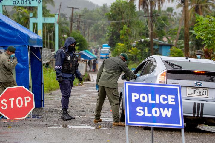 Fiji security forces inspect cars at a security check post at a residential area as they enforce face mask protocols in Fiji's capital Suva.
