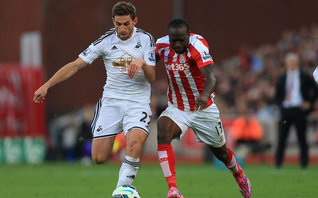 Stoke City winger Victor Moses tangles with Swansea's Angel Rangel