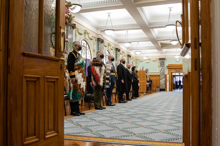 The three Service Chiefs and the Clerk of the House stand for the Governor General to pass