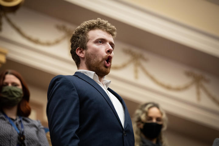 Opera singer Samuel McKeever further elevates the chamber's already lofty ceiling with a triumphant double forte rendition of the National Anthem