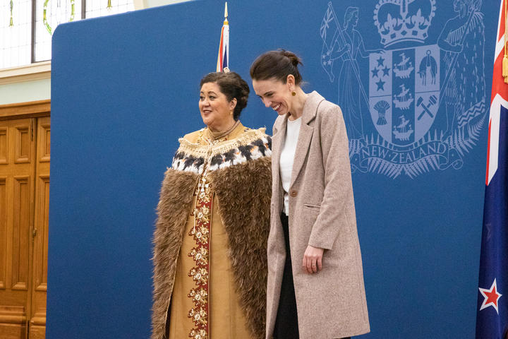 Dame Cindy Kiro cracks up the Prime Minister while they await a portrait