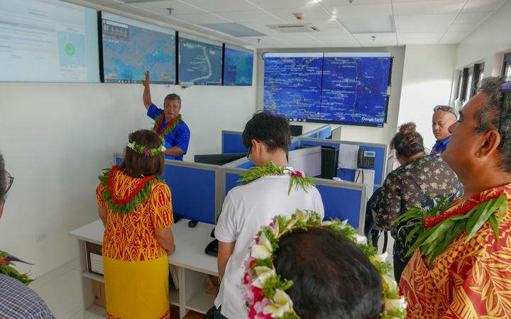 Marshall Islands Marine Resources Authority Director Glen Joseph (top left)  gives visitors to MIMRA's recently opened headquarters building a look at monitoring, control and surveillance tools the fisheries authority uses to managed the tuna fisheries.