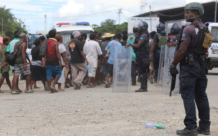 Armed police on guard in Honiara. 