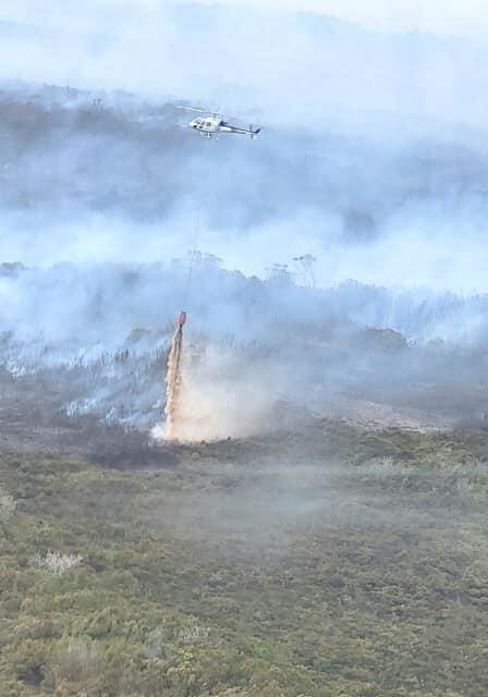 Firefighters with monsoon buckets continued to clean firewalls and vegetation around the perimeter to contain the blaze in Kaimaumau on December 20, 2021.