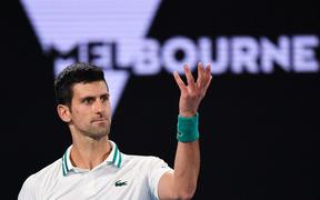 (FILES) In this file photo taken on February 21, 2021, Serbia's Novak Djokovic reacts after a point against Russia's Daniil Medvedev during their men's singles final match on day fourteen of the Australian Open tennis tournament in Melbourne.