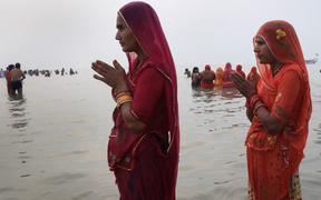 A Hindu devotee prays after taking a holy dip in the Bay of Bengal during the Gangasagar Mela, at Sagar Island, some 150 kilometres south of Kolkata on January 14, 2021.  