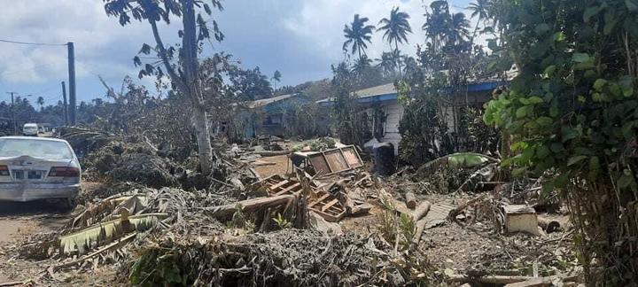 Ash and debris covering houses and a road in Nuku'alofa, Tonga.