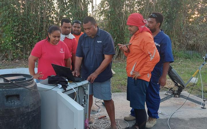 Digicel Tonga’s technical team working on satellite link equipment to restore internet connection