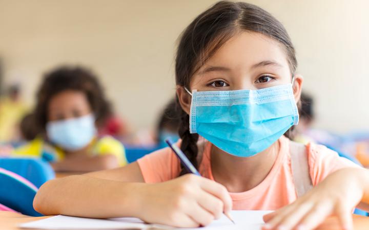 students wearing  mask and  studying in the classroom.