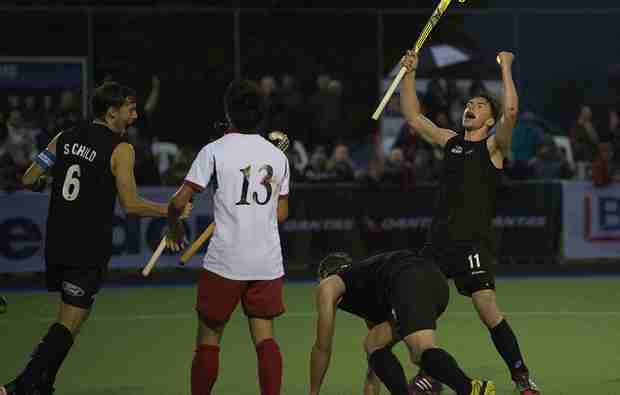 New Zealand hockey players Simon Child and Jacob Smith celebrate a goal against Japan 2014.