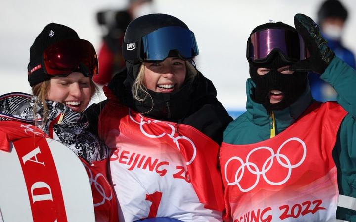 (L-R) Julia MARINO of United States of America, Zoi SADOWSKI SYNNOTT of New Zealand and Tess COADY of Australia celebrate during Women's Snowboard Slopestyle final run at Genting Snow Park H & S Stadium on February 6, 2022. 