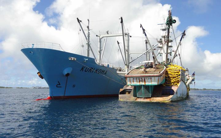 Marshalls 201 purse seiner, at right tied to a tuna transshipment carrier vessel, is one of several thousand ships globally that are registered in the Marshall Islands, which operates the world's third largest ship registry. 