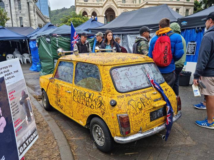 A graffiti covered car parked at the protest camp at Parliament. 