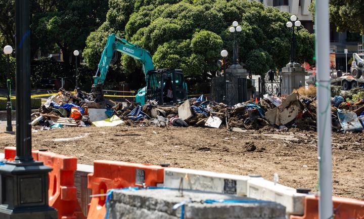 Piles of rubbish and debris are removed from Parliament's lawns