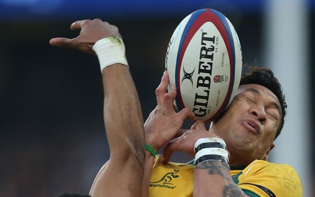Israel Folau grimaces as he goes for a high ball at Twickenham