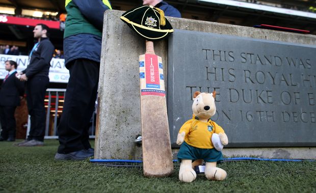 A cricket bat, a cap and a Wallaby mascot sit beside the Twickenham pitch in memory of Phil Hughes