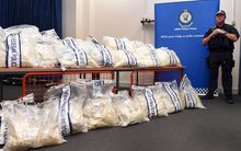 An Australian Federal Police officer stands guard over some of the seized drugs.
