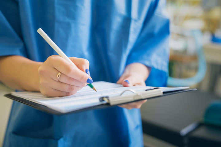 Medical professional signing a document.