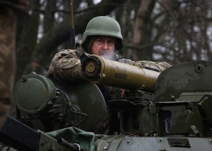A Ukrainian soldier stands on an armoured personnel carrier (APC), not far from the frontline with Russian troops, in Izyum district, Kharkiv region on 18 April, 2022.