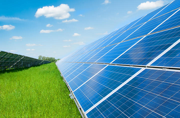 Solar panels, grass and and blue sky. 