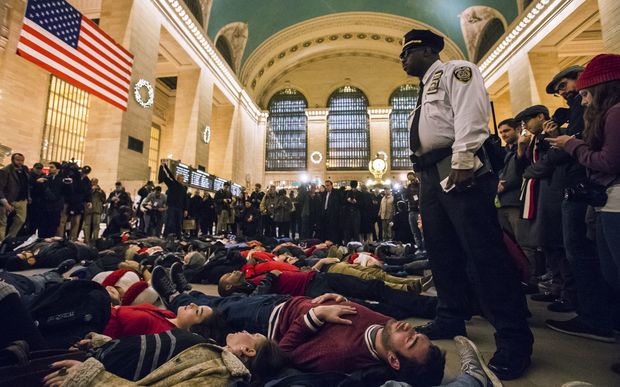 Activists stage a 'die-in' at New York's Grand Central station demanding justice over Eric Garner's death.
