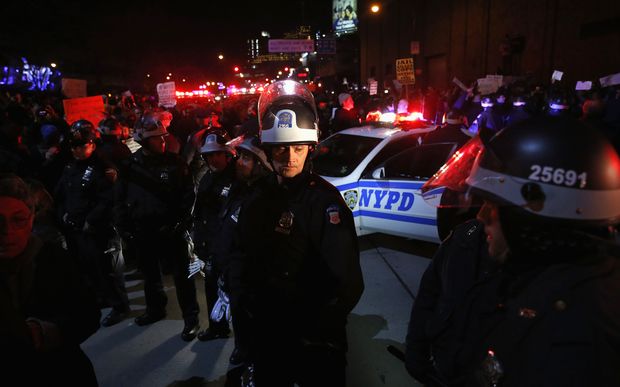 NYPD police stand guard on the city's West Side Highway as protestors block traffic.
