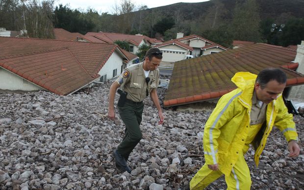 Houses are damaged after heavy rain triggered a mudslide in Ventura County, California on 12 December 2014 (local time). 