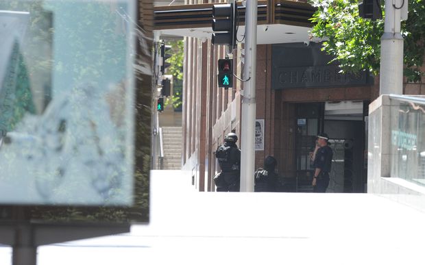 NSW Public Order and Riot Squad Police are seen outside the Lindt cafe in the central business district of Sydney.