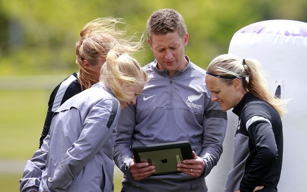 Football Ferns coach Tony Readings looks at video footage with his players