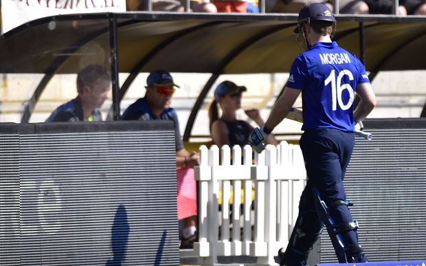 England's captain Eoin Morgan walks from the field after being caught by New Zealand's Trent Boult.
