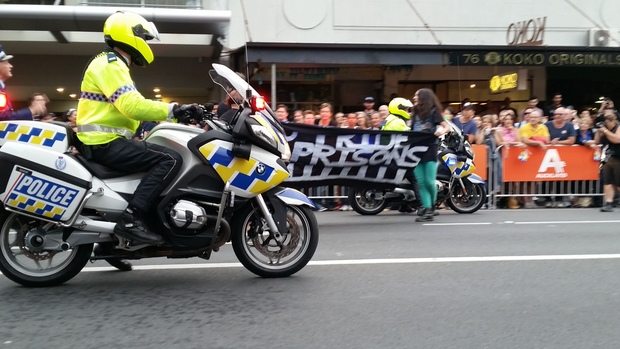 Protesters enter the route of Auckland's Pride Parade with a banner reading 'No Pride in Prisons'.