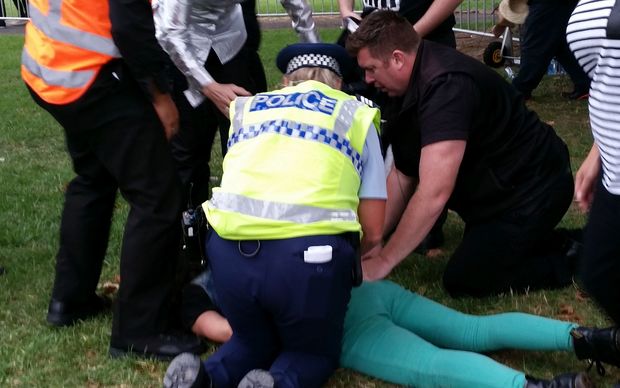 A protestor being restrained at the Auckland Pride Parade.