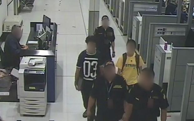 CCTV images of the teenage brothers with Sydney Airport officials .