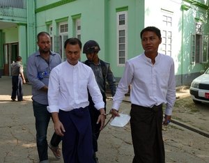 Phillip Blackwood (left) led into court in Yangon with Tun Thurein and Htut Ko Ko Lwin.