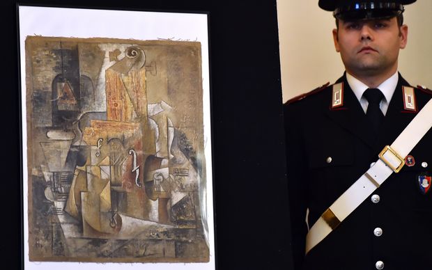 The Picasso painting Violin and Bottle of Bass displayed during a press conference in Rome.