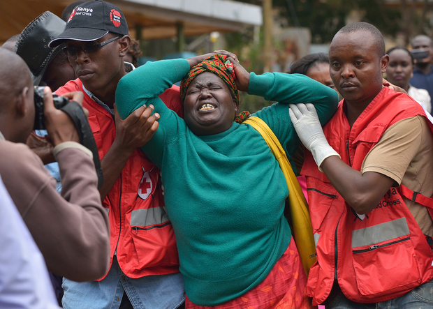 Red Cross members comfort a relative of one of those killed in the attack.