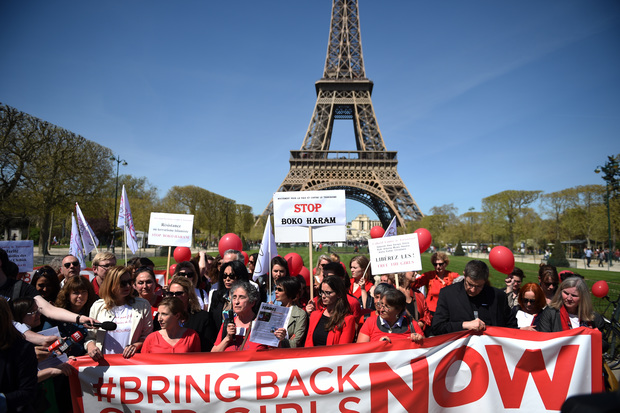 Protesters stand in front of the Eiffel Tower in Paris.