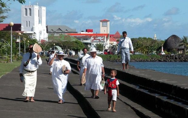 Samoans walking on the waterfront in Apia